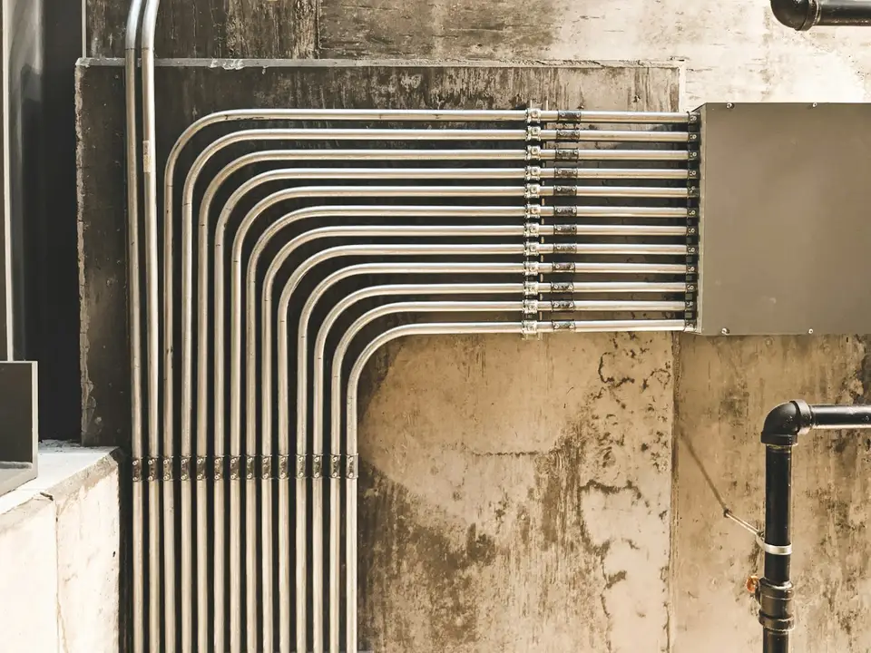 Metal water pipes along a building wall