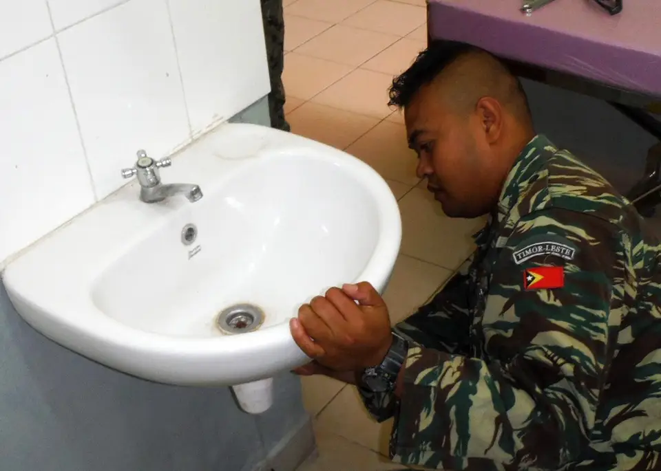 Licensed plumber working on a residential repair